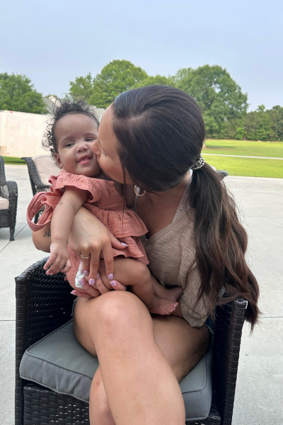 Becca kissing her daughter