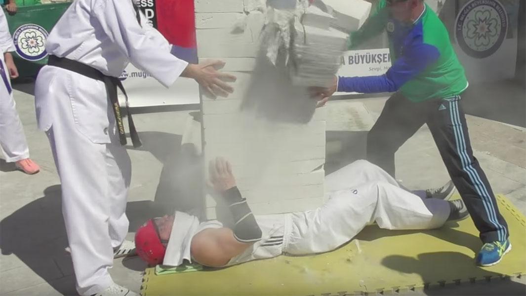 Video: Martial arts pro breaks concrete blocks on his body in world record attempt