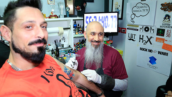 Italian tattoo artist reclaims record for 57 hour inking marathon