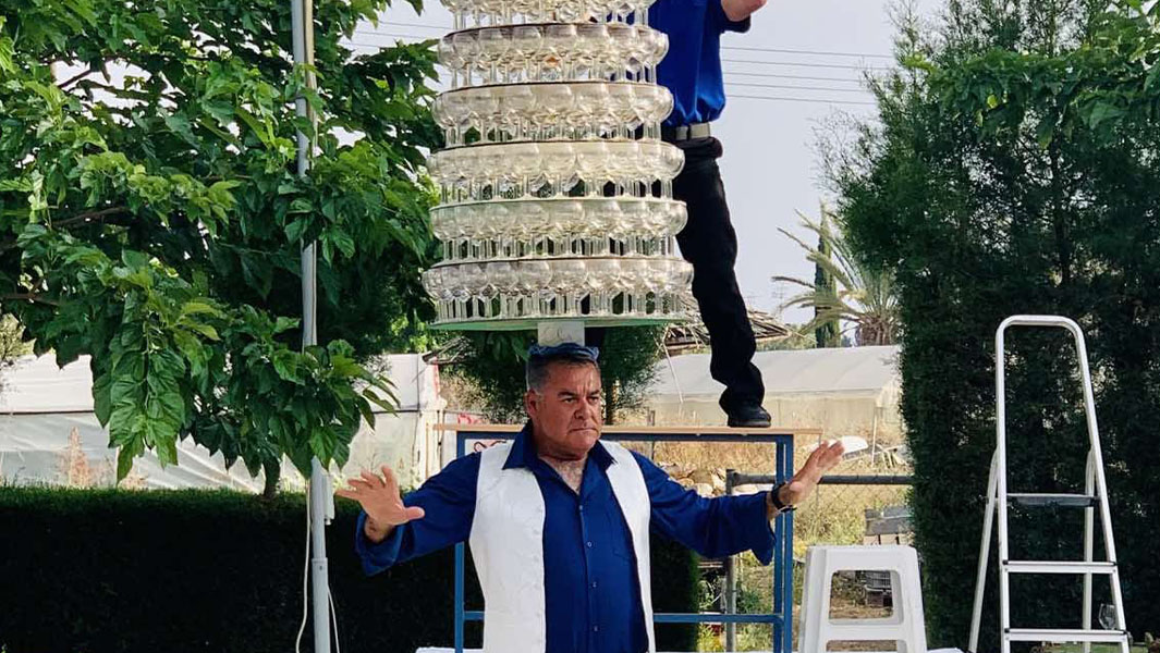 Cypriot man shatters record with 319 wine glasses balanced on head