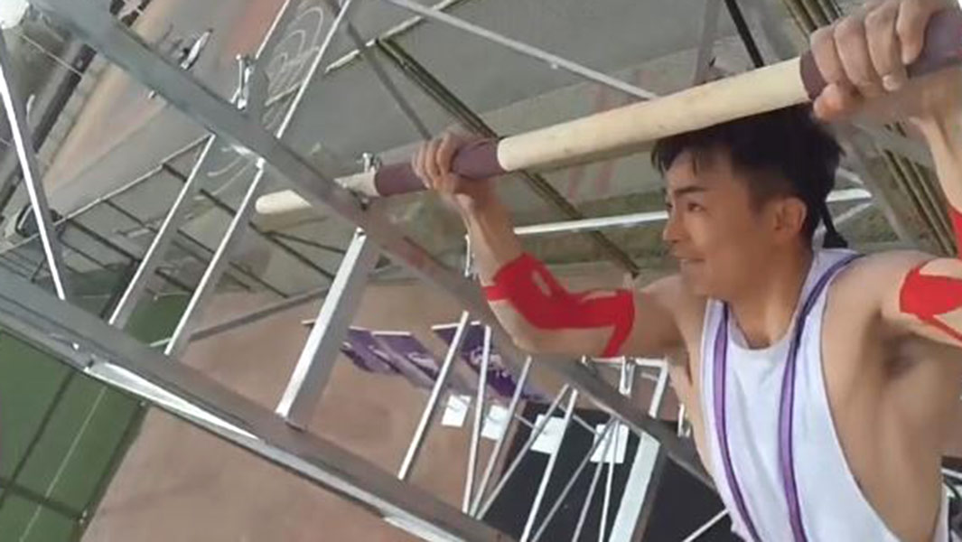Pull ups record holder raises the bar as he ascends tower while completing demanding exercise