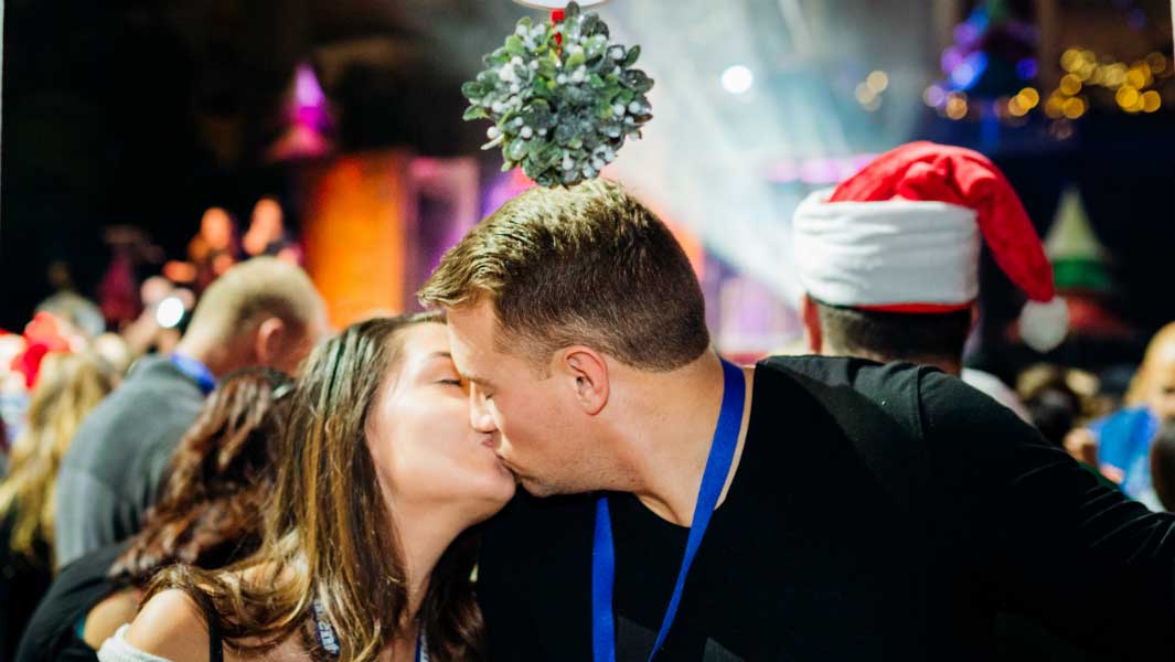 Hundreds of couples get close under the mistletoe for kissing record attempt