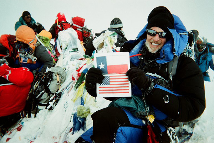 Proud Texan Victor waves his state flag on the summit of Everest