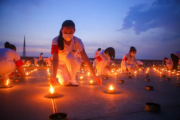 People attempting largest flame record using candles