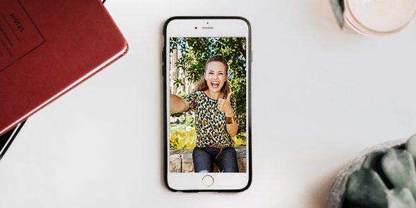 Image of a mobile phone with a person doing a selfie for an online album record attempt