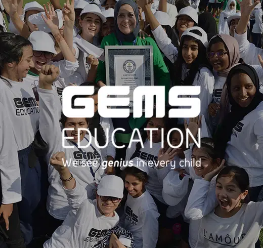 gems education - woman holding gwr certificate surrounded by kids