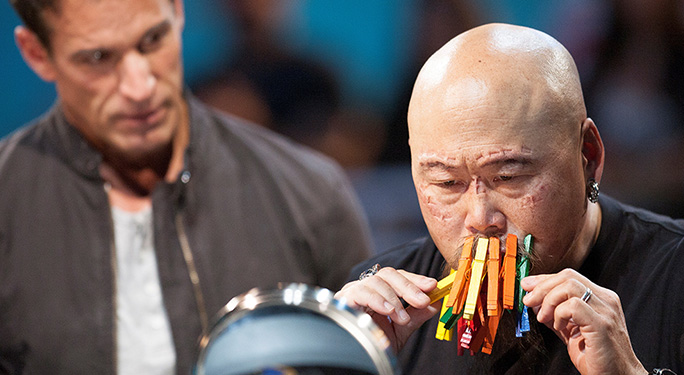 man with pegs on his mouth