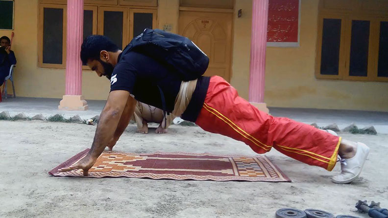 Most two finger push ups in one minute carrying a 40 lb