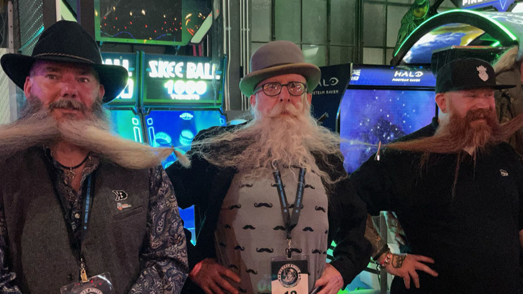 men forming the longest beard chain