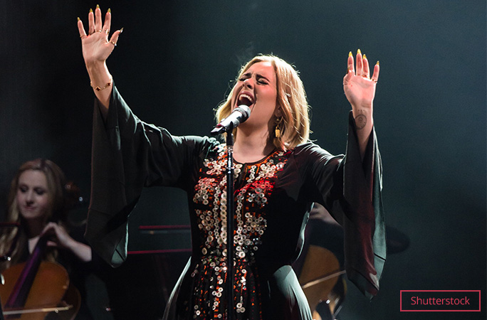 adele belts out a song on stage