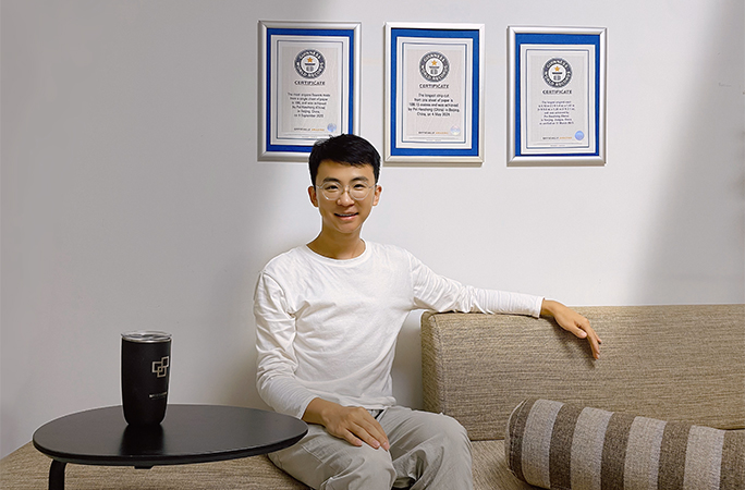 Pei posing in front of his certificates