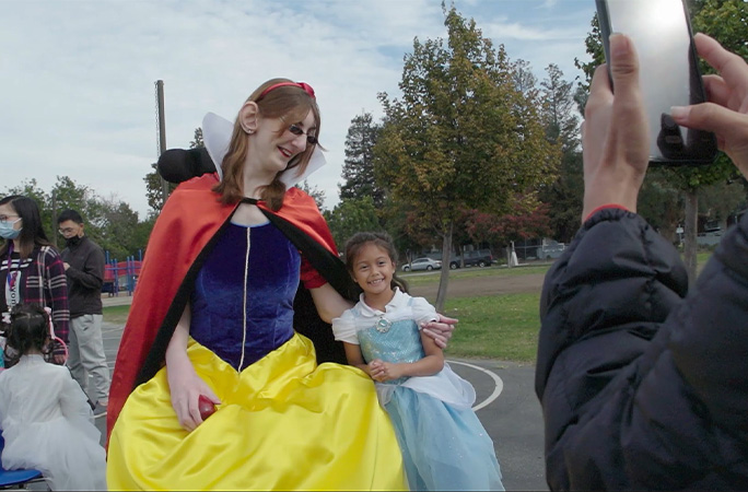 Rumeysa taking a picture with a little girl