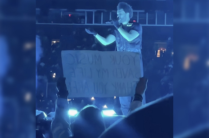 Karla holding up a sign to tell The Weeknd his music saved her life