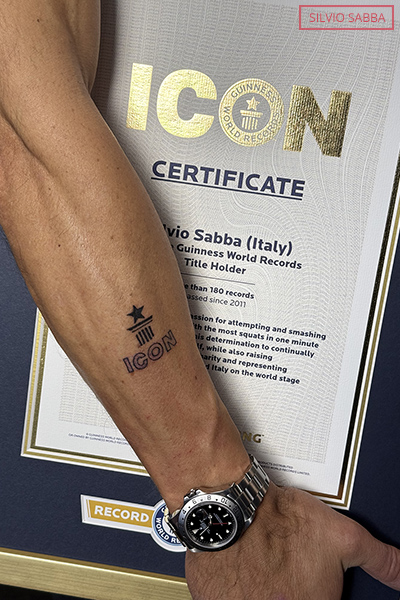 Silvio holding certificate with tattoo