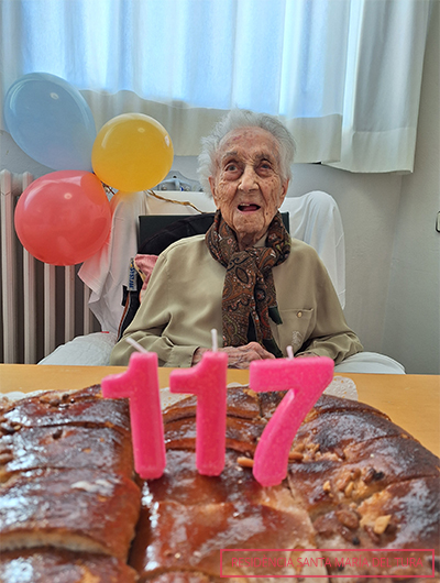 Maria Branyas sitting behind birthday cake