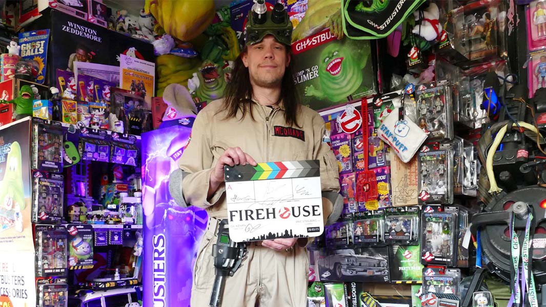 Darren standing among his ghostbusters collection