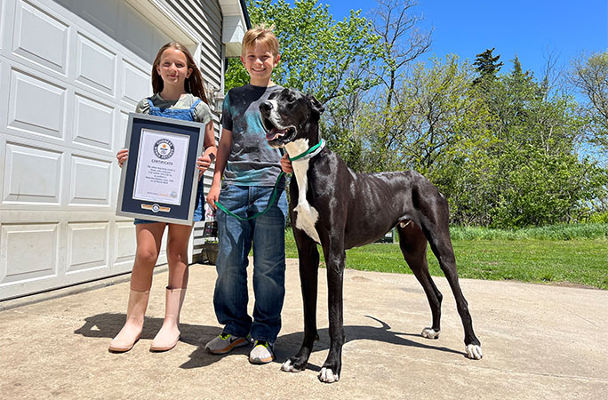 Kevin standing next to Alexander and Ava, who is holding his certificate