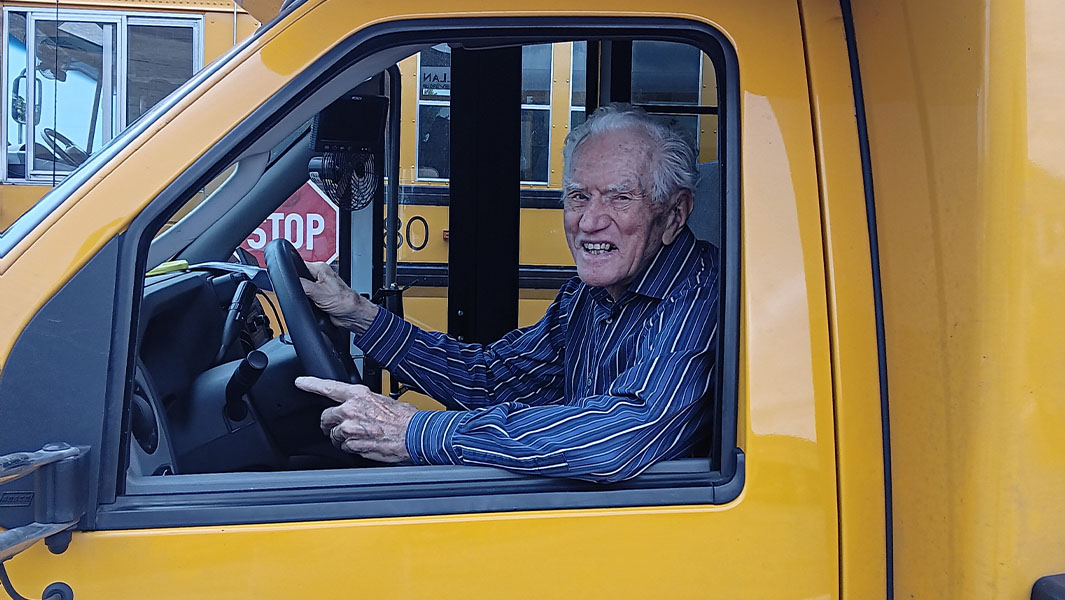 James Oppegard smiling while sitting in school bus