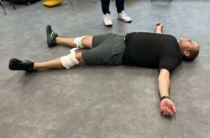 David lying on the floor wearing lots of T-shirts