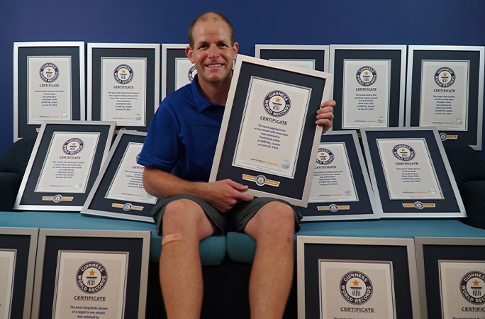 David surrounded by his certificates