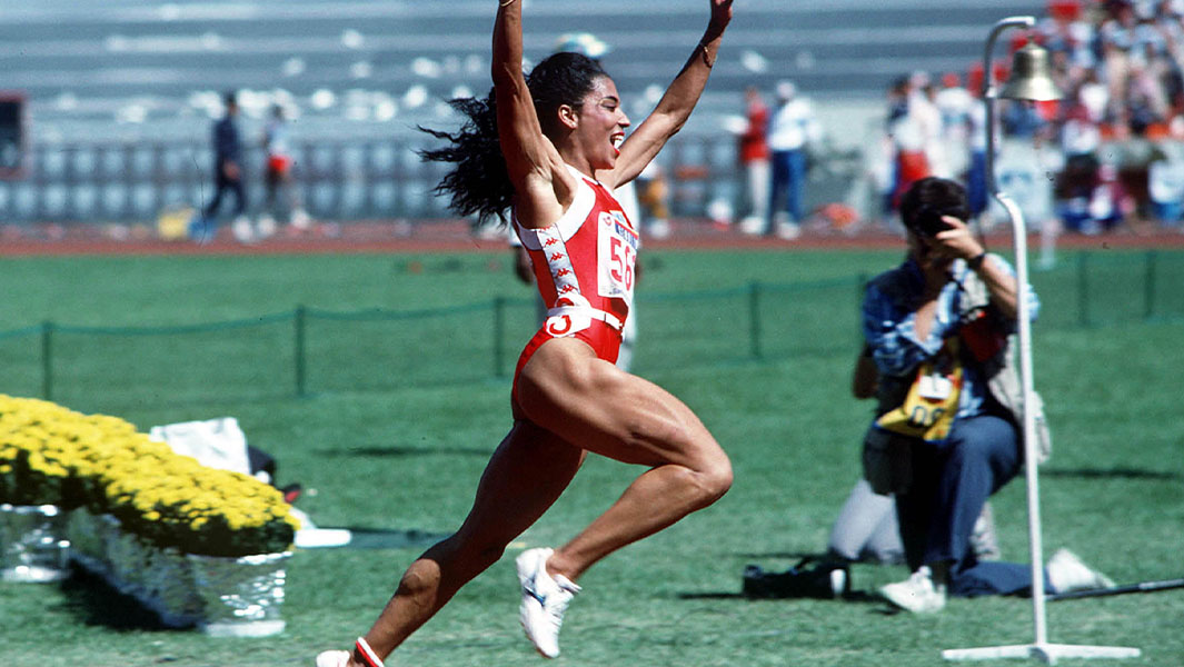 Griffith Joyner running with arms up