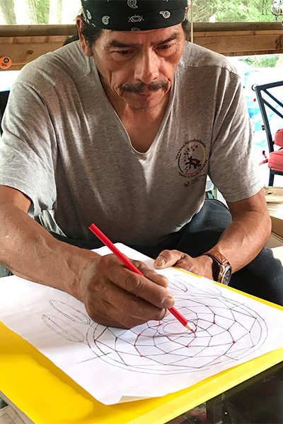 Bobbie drawing his dreamcatcher design