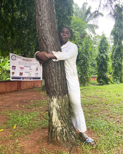 Abdul hugging a tree