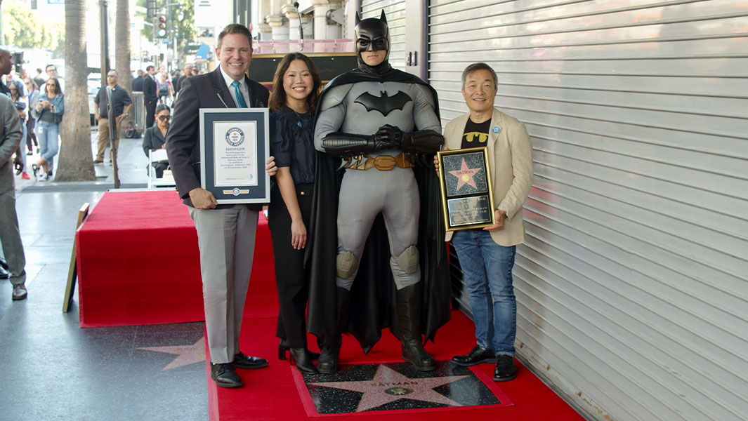 split image of Batman character and certificate presentation
