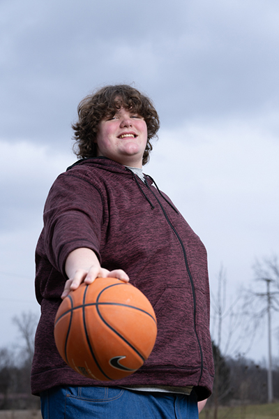 Eric holding a basketball to the camera