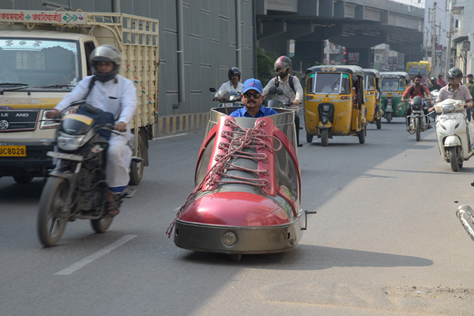 Sudhakar driving down the streets