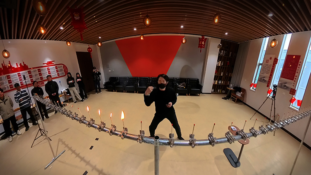 Zhang throwing playing cards at matches