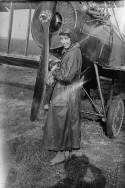 Katherine Stinson posing by her plane