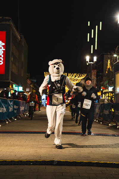 Gill at the finish line in her polar bear costume
