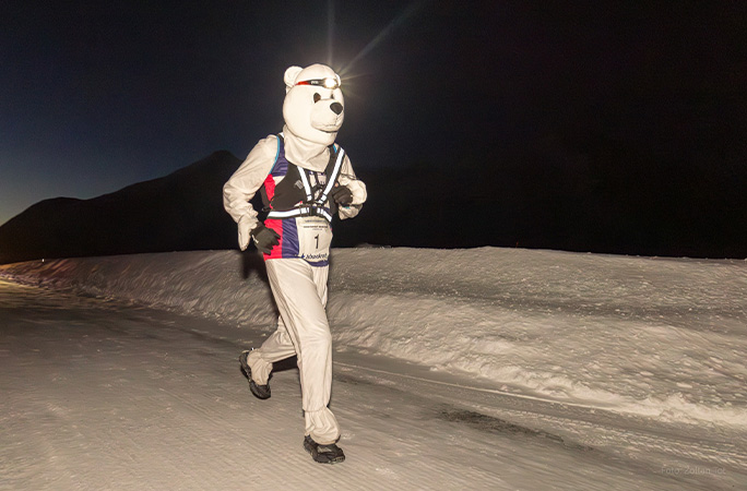 Gill running through the snow dressed as a polar bear