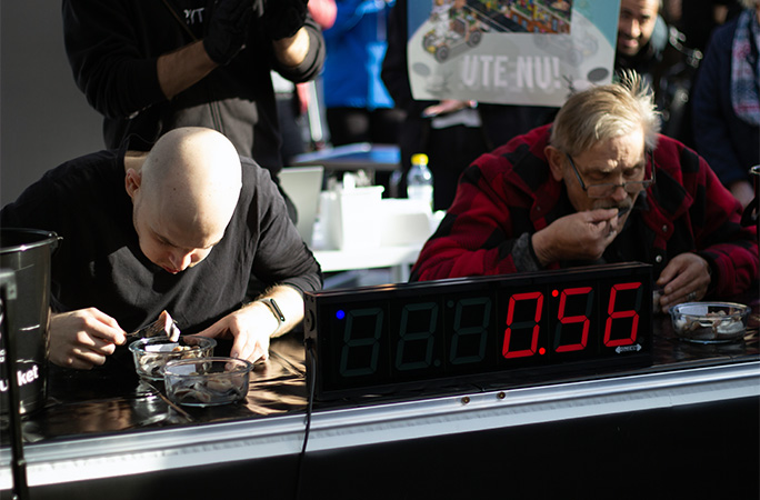 Contestants eating fermented herring