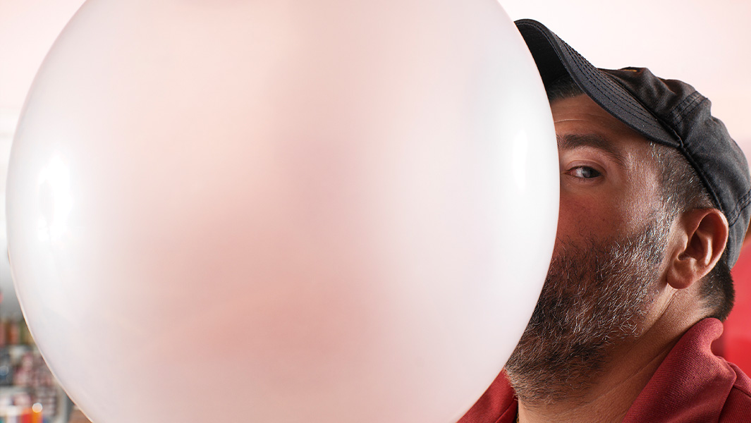 split image of Chad blowing the bubble and it bursting