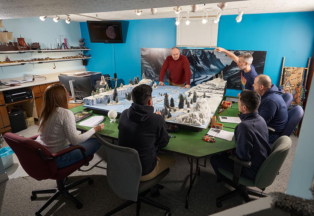 Players in Robert Wardaugh's game discuss what to do at the table