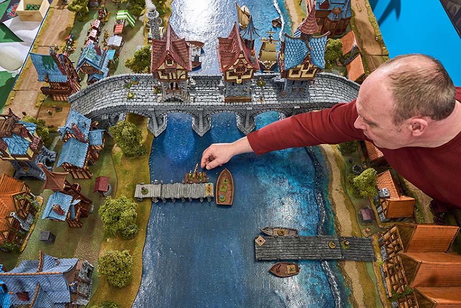 Robert Wardaugh adjusts player figurines as the party moves through a model town