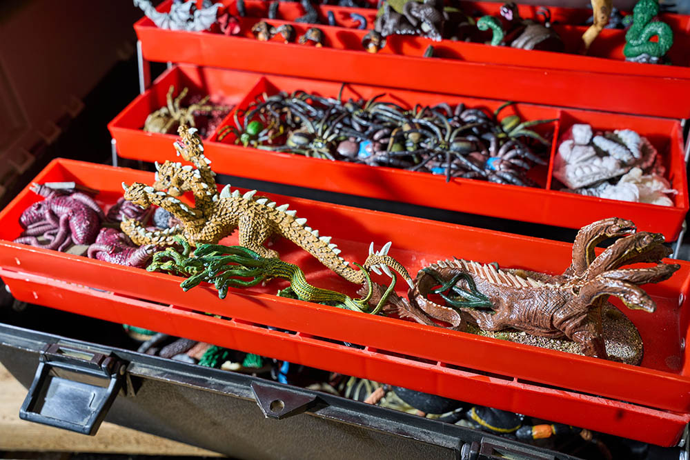 A tacklebox filled with assorted fantasy monster figurines