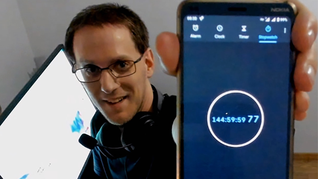 split image of Szabolcs playing the game and holding up a timer