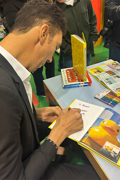 Sultan signing books