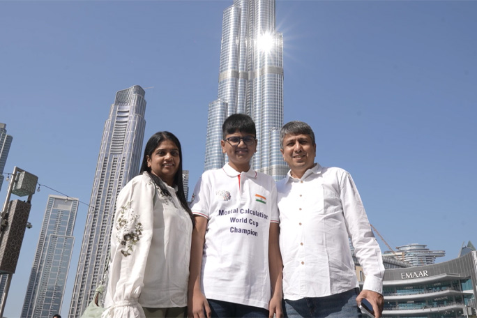 Aaryan with parents in front of Dubai buildings