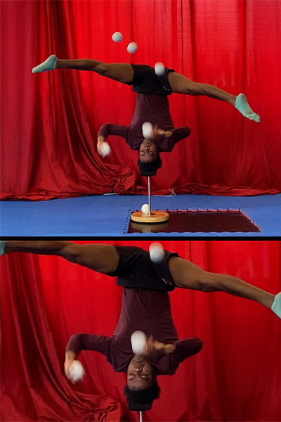 Jose showing off his juggling skills while balancing on their head