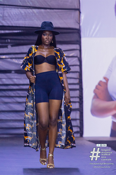 Ololade walking the catwalk in a blue outfit