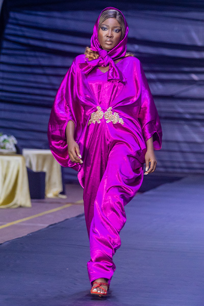 Ololade on the catwalk in a pink outfit