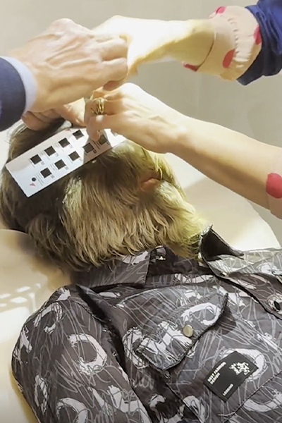 Lalit having his hair measured