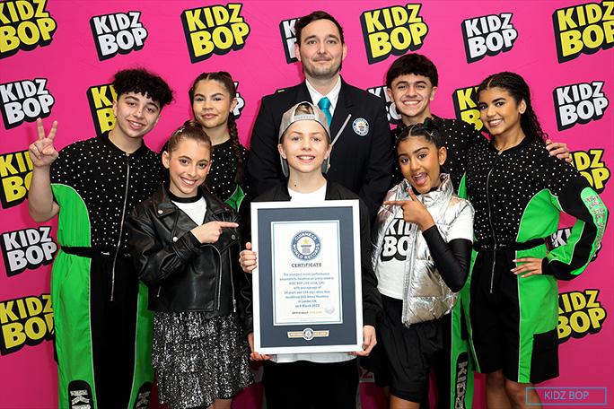 KIDZ BOP showing certificate on stage