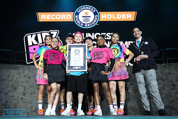 KIDZ Bop with adjudicator and certificate smiling