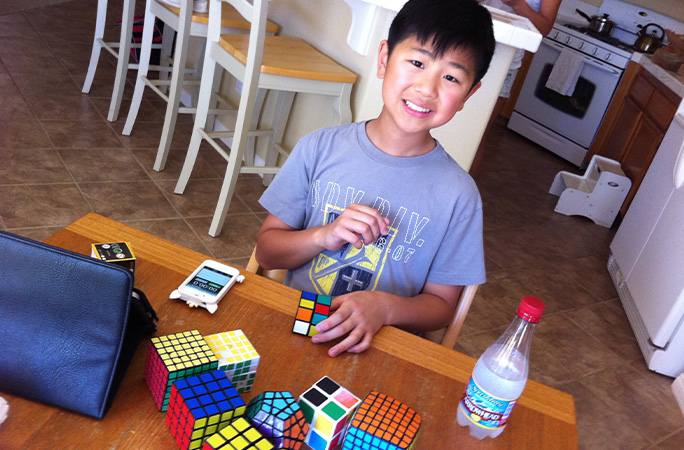 Max playing with puzzle cubes as a child