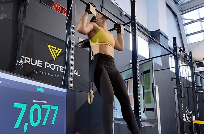 side view of Olivia doing pull ups